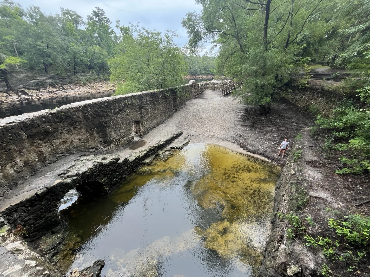 Wide view of Suwannee Springs with stone ruins clear spring water forest and the Suwannee River