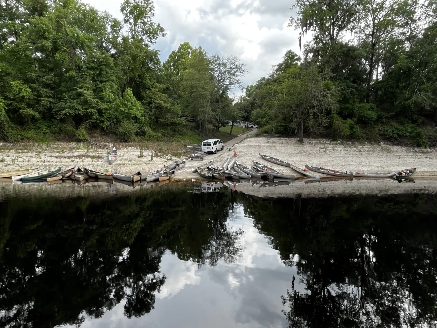 Canoes and kayaks lined up at the Suwannee River Outpost boat ramp and day trip take-out
